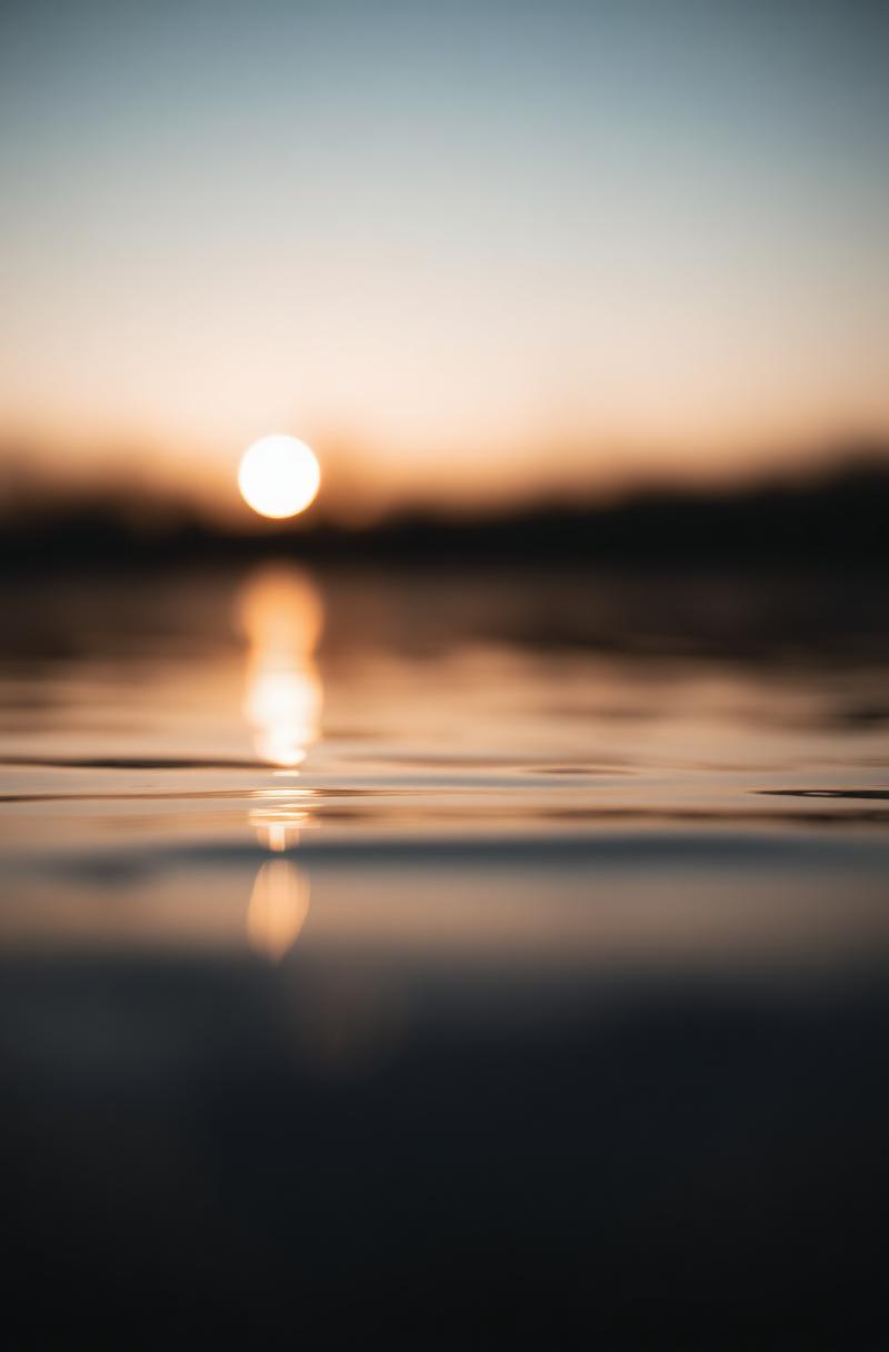 Light reflecting on still water at dusk